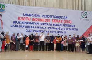 TRI ADHIANTO PLT WALI KOTA BEKASI SERAHKAN KARTU BPJS DI TIGA KECAMATAN KOTA BEKASI